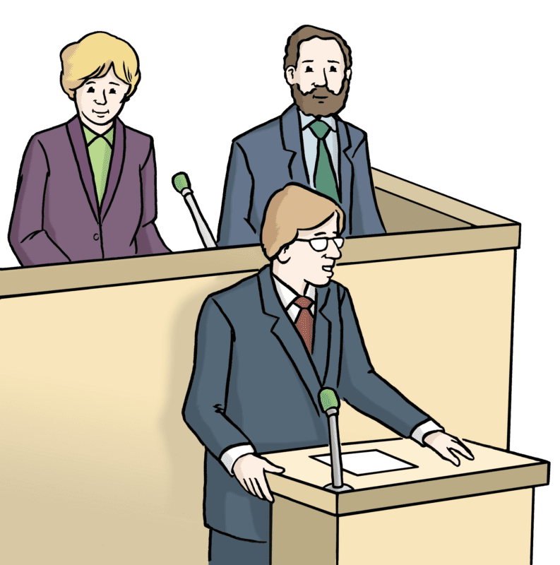 Drei Personen nehmen an einer formellen Debatte teil. Ein Mann steht am Podium und spricht, während eine Frau und ein weiterer Mann hinter ihm stehen und aufmerksam zuhören. Alle sind in Geschäftskleidung gekleidet.